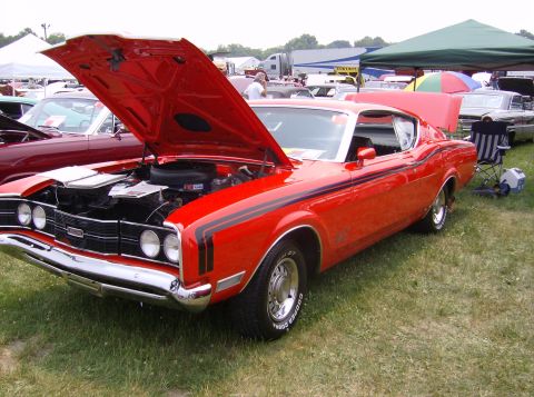 1970 Ford Ranchero - A red 1970 Ford Ranchero is displayed with its hood open at an outdoor event.