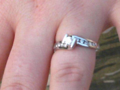 1986 Ford Bronco - Diamond ring with channel-set stones on a finger.