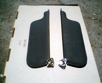 1973 Ford Ranchero - Two sun visors are displayed on a cardboard box, likely for sale as automotive parts.