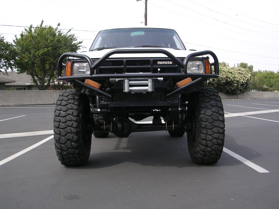 Front view of a white 1985 Toyota 4Runner with a winch and bull bar