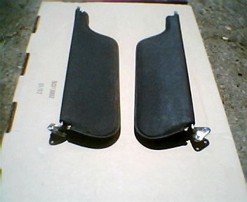 1973 Ford Ranchero - Two dark-colored sun visors are laid out on a piece of cardboard.