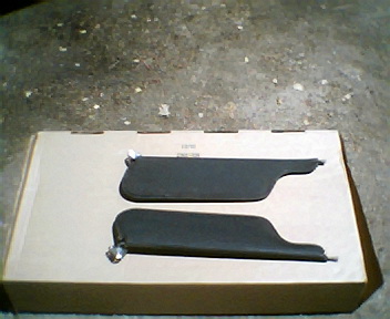1973 Ford Ranchero - Two sun visors are displayed on a cardboard box, likely for sale or storage.