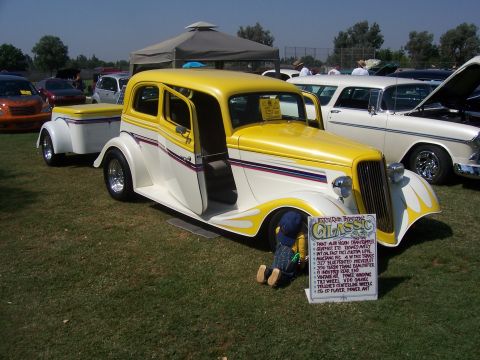 2002 Ford Mustang - Custom hot rod with trailer at a car show, with other vehicles visible in the background.