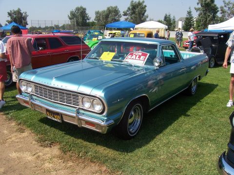 2002 Ford Mustang - A teal 1964 Chevrolet El Camino is displayed at an outdoor event, with a 'For Sale' sign visible in the windshield.