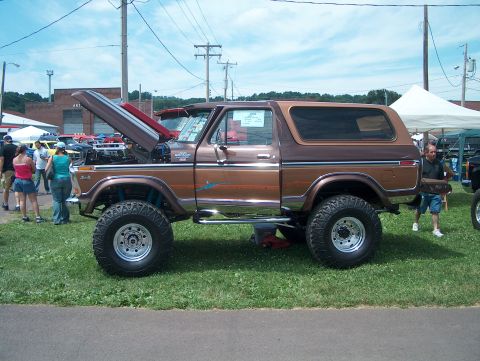 1978 Ford Bronco - This lifted 1978 Ford Bronco is on display at an outdoor car show with its hood open.