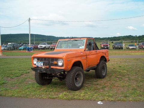 1978 Ford Bronco - This 1978 Ford Bronco is parked on grass with other vehicles in the background.