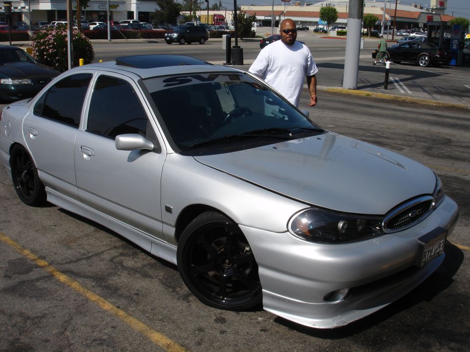 Silver sedan with black rims, SVT banner on windshield