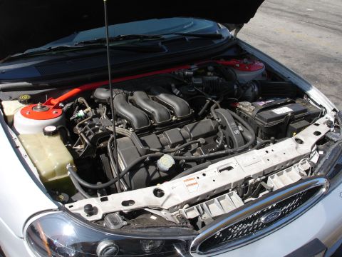 1993 Ford Taurus - The engine bay of a car, showing the V6 engine and various components under the hood.