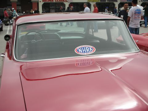 1998 Ford Crown Victoria - Interior view of a classic red car with an NHRA drag racing sticker on the back window.