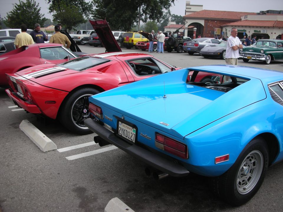 Blue sports car rear view, California license plate 2YKD127, black bumper, dual exhaust pipes