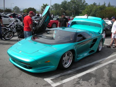 1998 Ford Crown Victoria - A teal Vector W8 Twin Turbo is displayed with its doors open at a car meet.