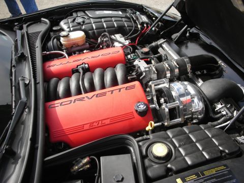 1998 Ford Crown Victoria - The engine bay features prominent red valve covers with "CORVETTE 5.7L" lettering and a polished supercharger.