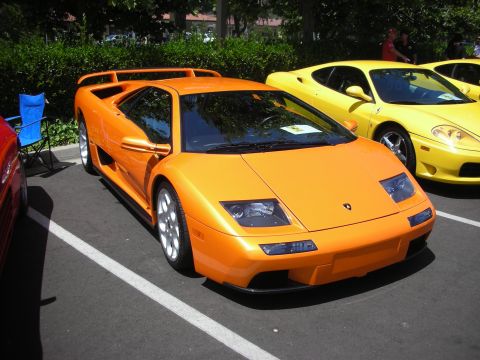 1998 Ford Crown Victoria - Orange Lamborghini Diablo and a yellow Ferrari parked at an outdoor event.