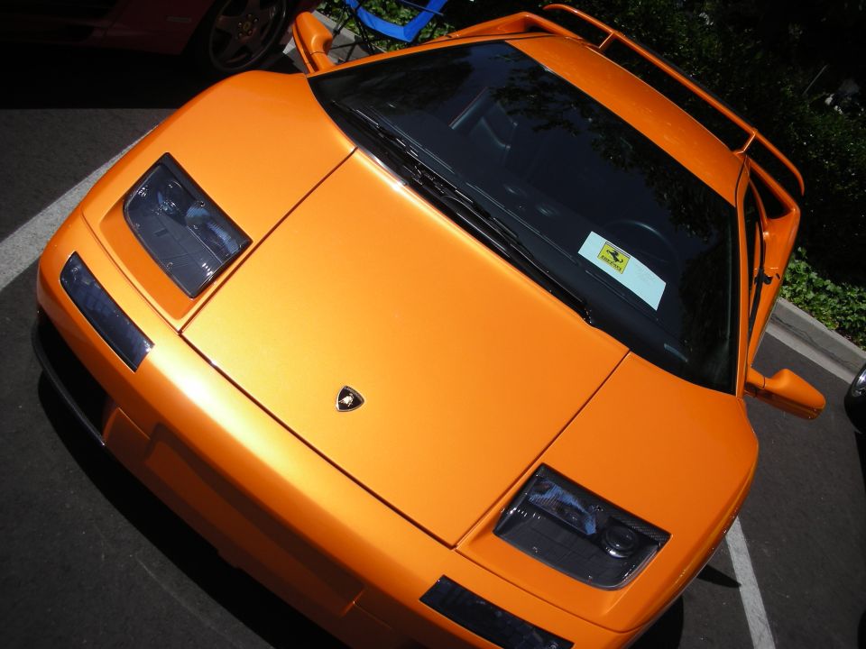 Orange Lamborghini Diablo parked, showing front end and side mirror