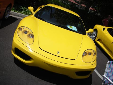 1998 Ford Crown Victoria - A bright yellow Ferrari sports car is parked in front, with another yellow car visible to the right.