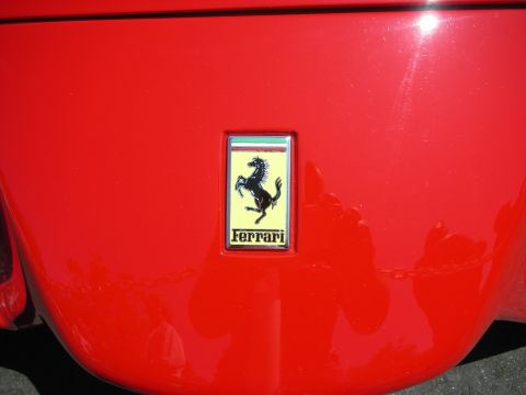 1998 Ford Crown Victoria - A close-up of a Ferrari emblem on a red vehicle.