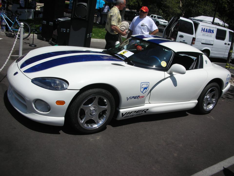 White Dodge Viper with blue stripes, side view, showing "Viper" text on the rocker panel