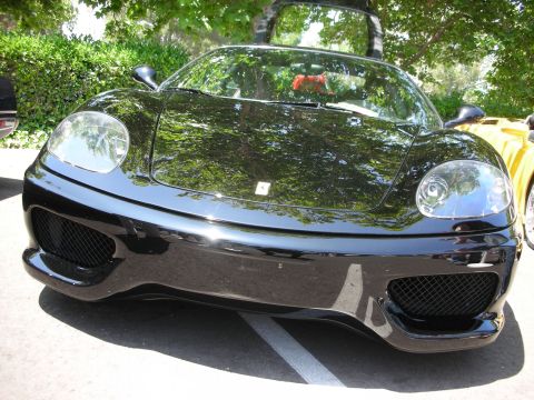 1998 Ford Crown Victoria - Front view of a black Ferrari 360 Modena parked outdoors, with a yellow car to its side.