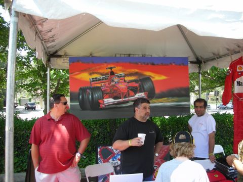 1998 Ford Crown Victoria - People gather under a tent displaying a painting of a Formula 1 race car.