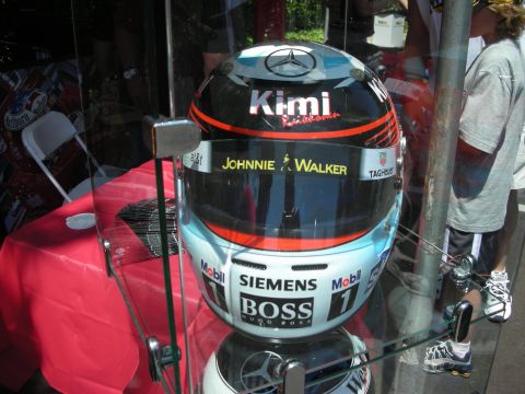 1998 Ford Crown Victoria - A racing helmet with various sponsor logos is displayed behind glass.