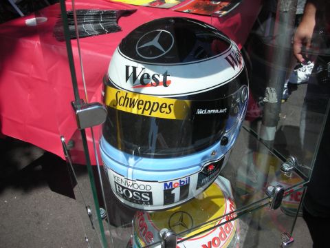 1998 Ford Crown Victoria - A racing helmet with various sponsor logos is displayed behind glass.