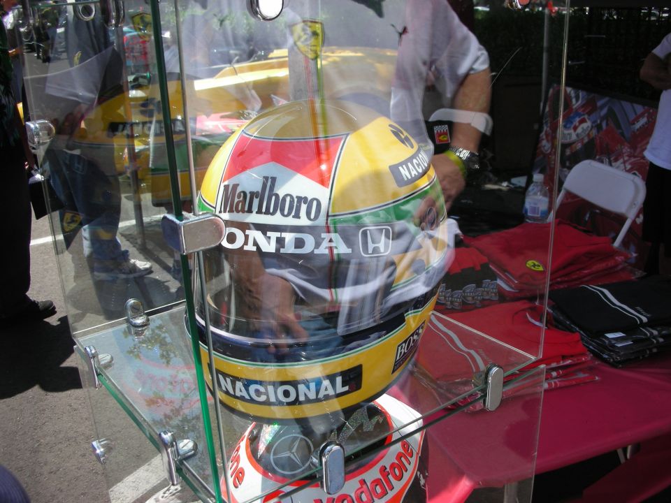 Ayrton Senna replica racing helmet with Marlboro and Honda logos, displayed in a glass case