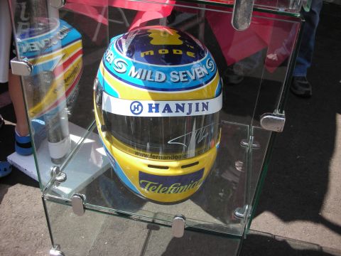1998 Ford Crown Victoria - A racing helmet with sponsor logos is displayed in a glass case.