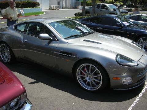 1998 Ford Crown Victoria - Gray Aston Martin Vanquish with aftermarket wheels and red brake calipers.
