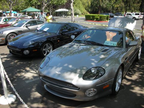 1998 Ford Crown Victoria - Two Aston Martin DB7s are parked side-by-side at an outdoor event.