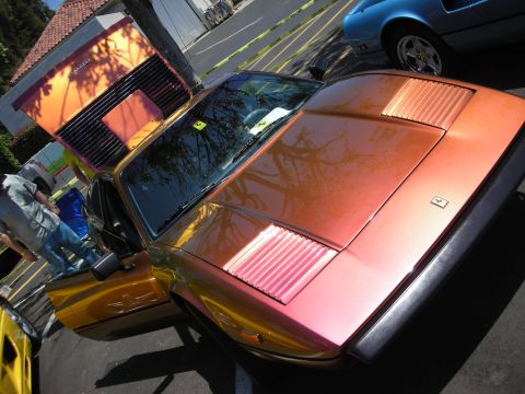 1998 Ford Crown Victoria - A Ferrari with a unique paint job is displayed at an outdoor event.