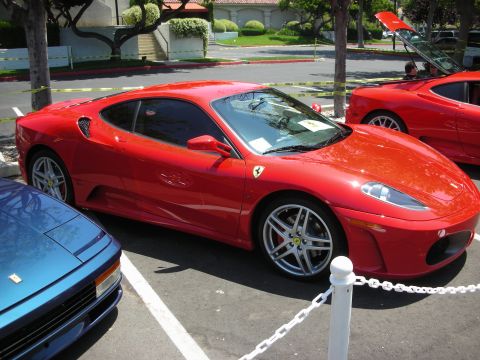 1998 Ford Crown Victoria - Two red Ferraris and a blue car are parked at an outdoor event.