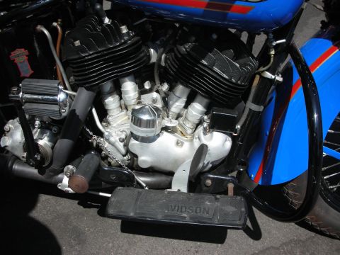 1998 Ford Crown Victoria - Close-up of a motorcycle engine with a Vids on footboard, showing blue and red paint details.