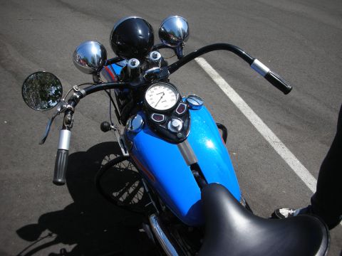 1998 Ford Crown Victoria - A blue motorcycle's dashboard and handlebars are visible from a top-down perspective.