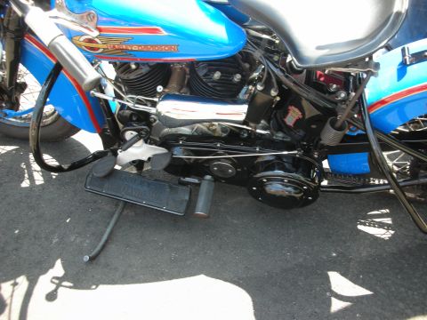 1998 Ford Crown Victoria - Close-up view of a blue motorcycle's engine and frame, red and gold stripe detailing on the fuel tank.