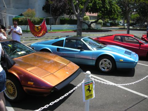 1998 Ford Crown Victoria - Three Ferraris are parked in a lot, with a Ferrari Owners Club sign visible.
