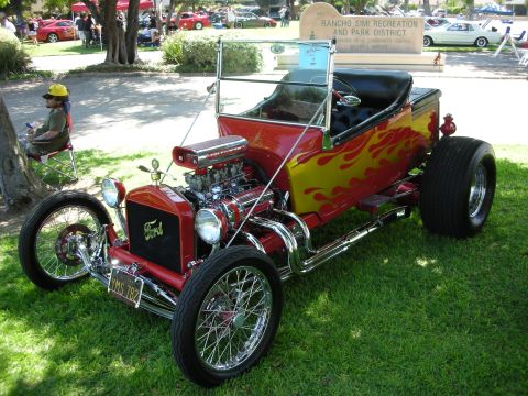1998 Ford Crown Victoria - A custom hot rod is displayed on a grassy lawn with other vehicles in the background.