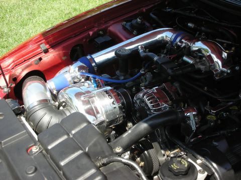 1998 Ford Crown Victoria - Close-up of a modified engine bay a Novi supercharger and polished intake components.