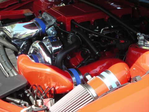 1998 Ford Crown Victoria - Close-up view of a modified engine bay with prominent turbocharger and custom intake system.