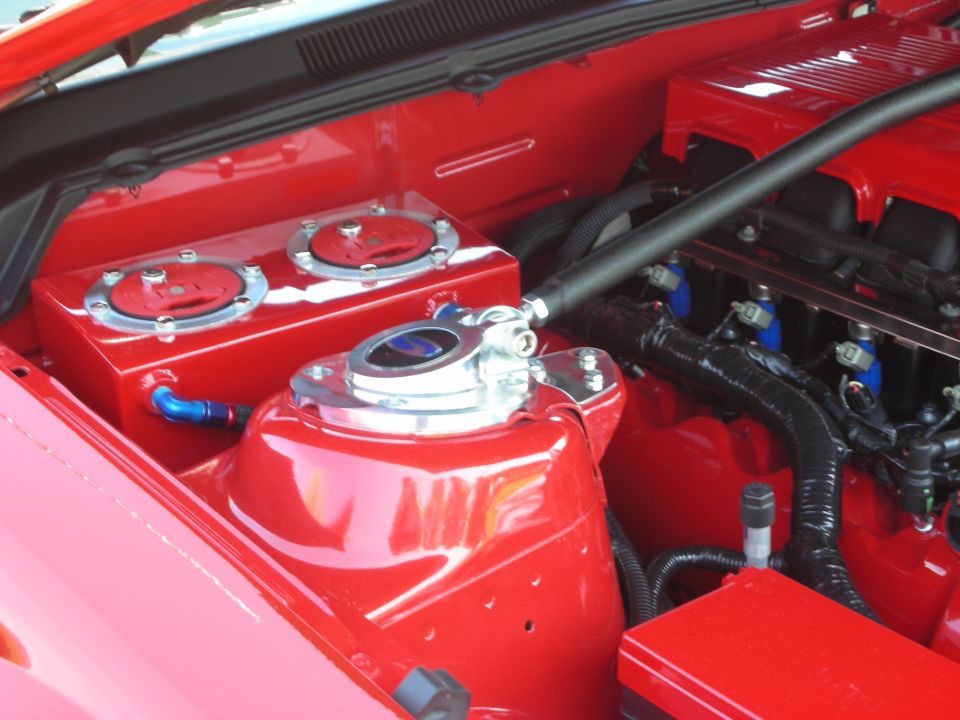 Red engine bay with dual fuel tanks and chrome accents