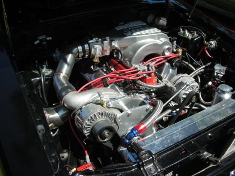 1998 Ford Crown Victoria - Close-up view of a modified engine bay, highlighting custom components and wiring.