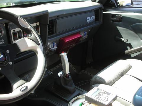 1998 Ford Crown Victoria - The interior of this car features a 5.0 Mustang badge on the dashboard and an aftermarket shifter.