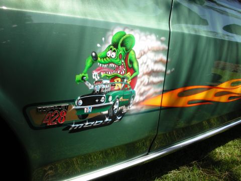 1998 Ford Crown Victoria - A green 1969 Ford Mustang Mach 1 displays custom airbrush art and flame decals on its side.