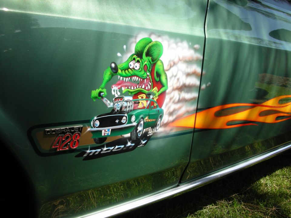 Green 1969 Ford Mustang Mach 1 with custom airbrush art of a rat driving a car and flame decals