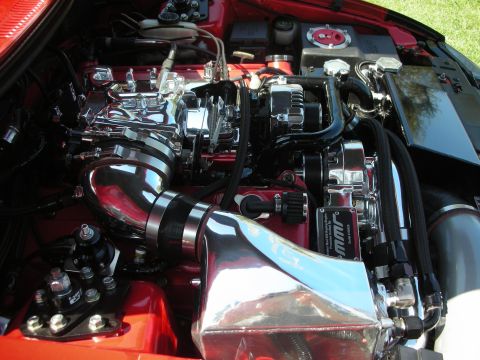 1998 Ford Crown Victoria - Close-up view of a modified engine bay with polished chrome components and red accents.