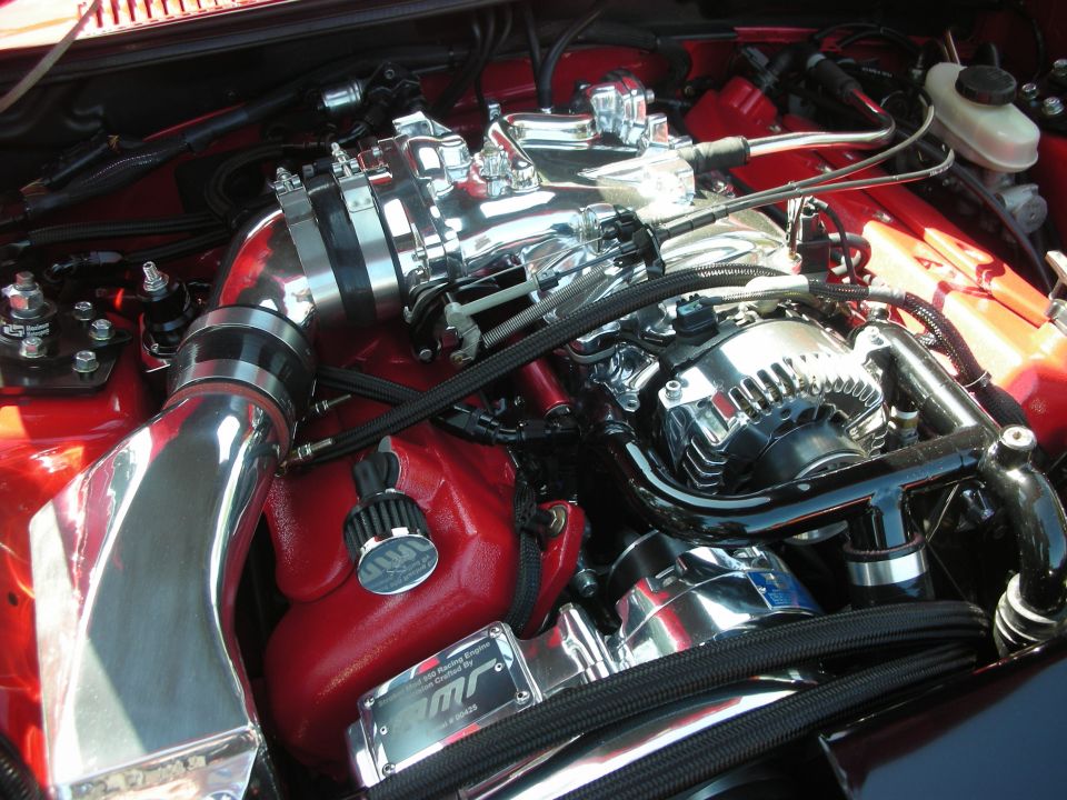Chrome intake manifold and alternator in red engine bay