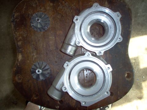 1996 Ford Probe - Turbocharger components are laid out on a wooden surface, ready for installation or repair.