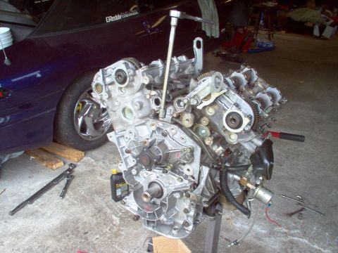 1996 Ford Probe - Engine assembly is partially disassembled, with tools nearby in a garage setting.