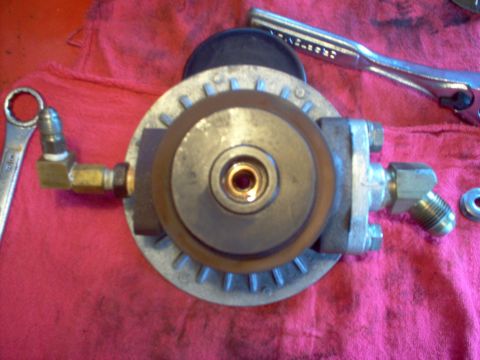 1996 Ford Probe - A close-up view of a fuel filter housing, brass fittings and resting on a red cloth with tools nearby.
