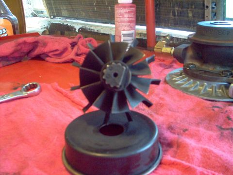 1996 Ford Probe - A turbocharger turbine wheel sits on a red cloth, ready for installation or repair, alongside a wrench and other automotive fluids.