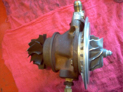 1996 Ford Probe - Turbocharger part with visible markings, likely a replacement or upgrade component.
